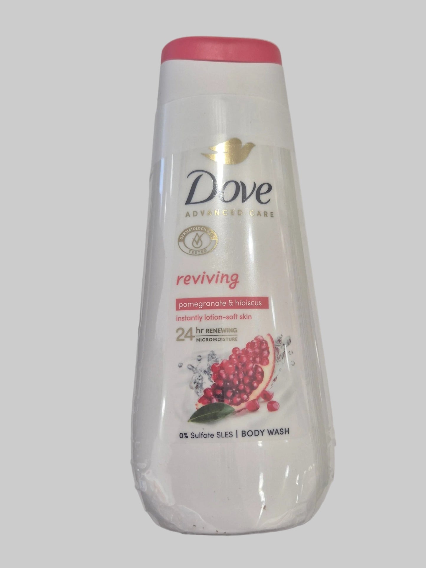 Dove body wash bottle with pomegranate design on a gray background