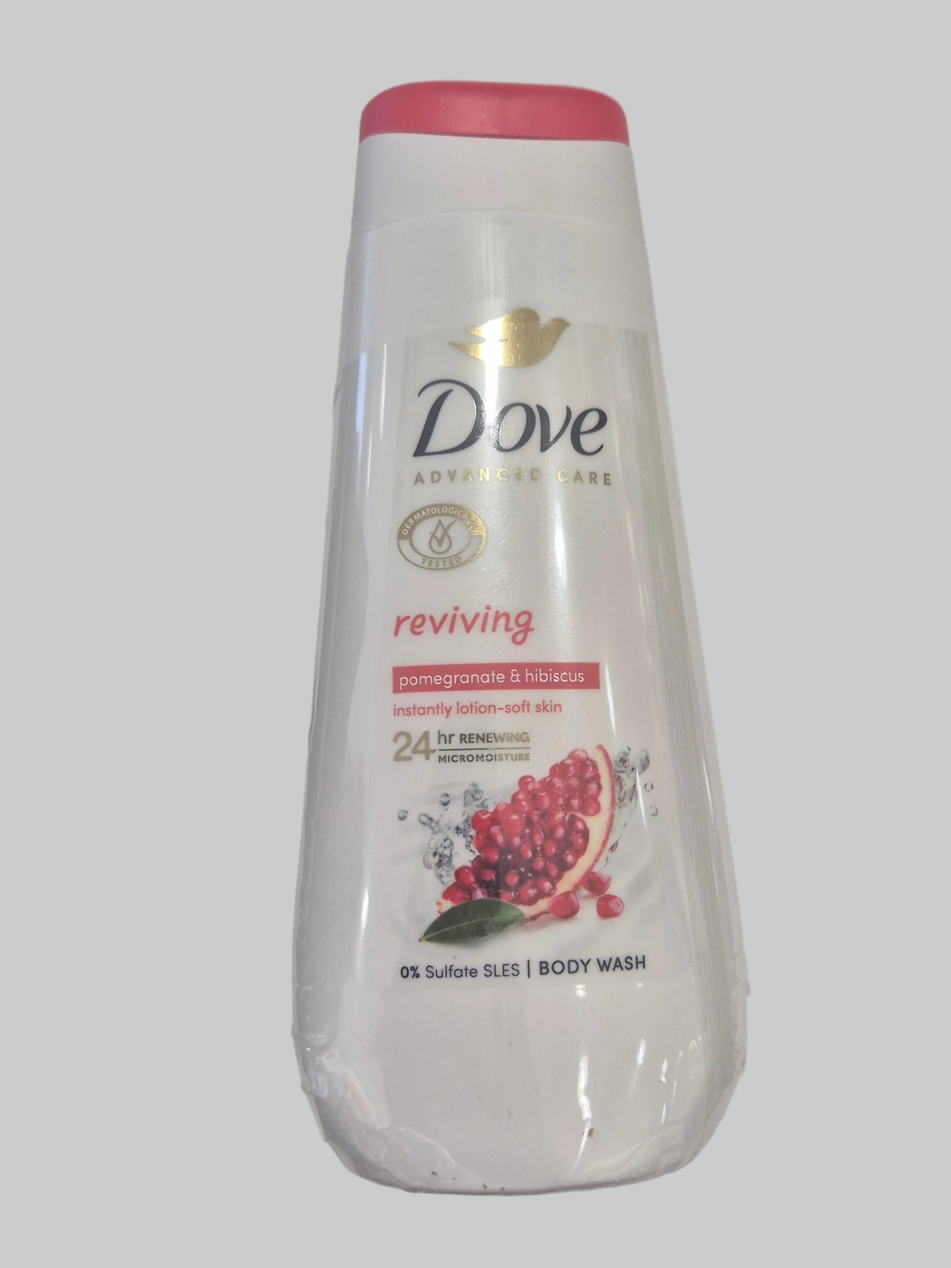 Dove body wash bottle with pomegranate design on a gray background