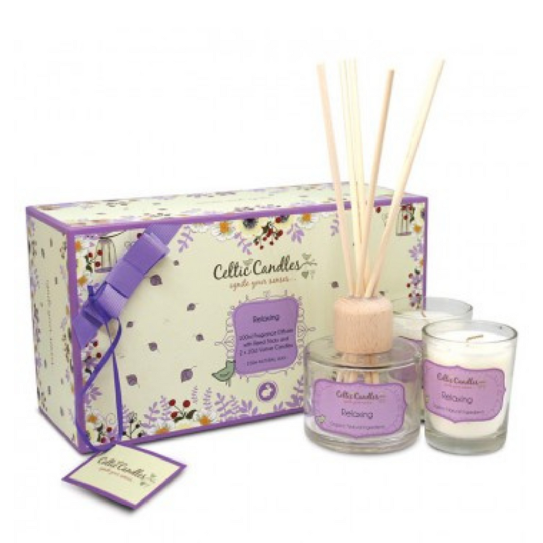 Celtic Candles Relaxing Gift Box contains natural oils of Clove Tarpenes, Turpentine, Mentha Arvensis, Geranium and Sweet Orange. Box includes a diffuser in clear glass, light brown reed sticks and 2 votive candles in clear glass holders. Flowery Box with a purple ribbon. 